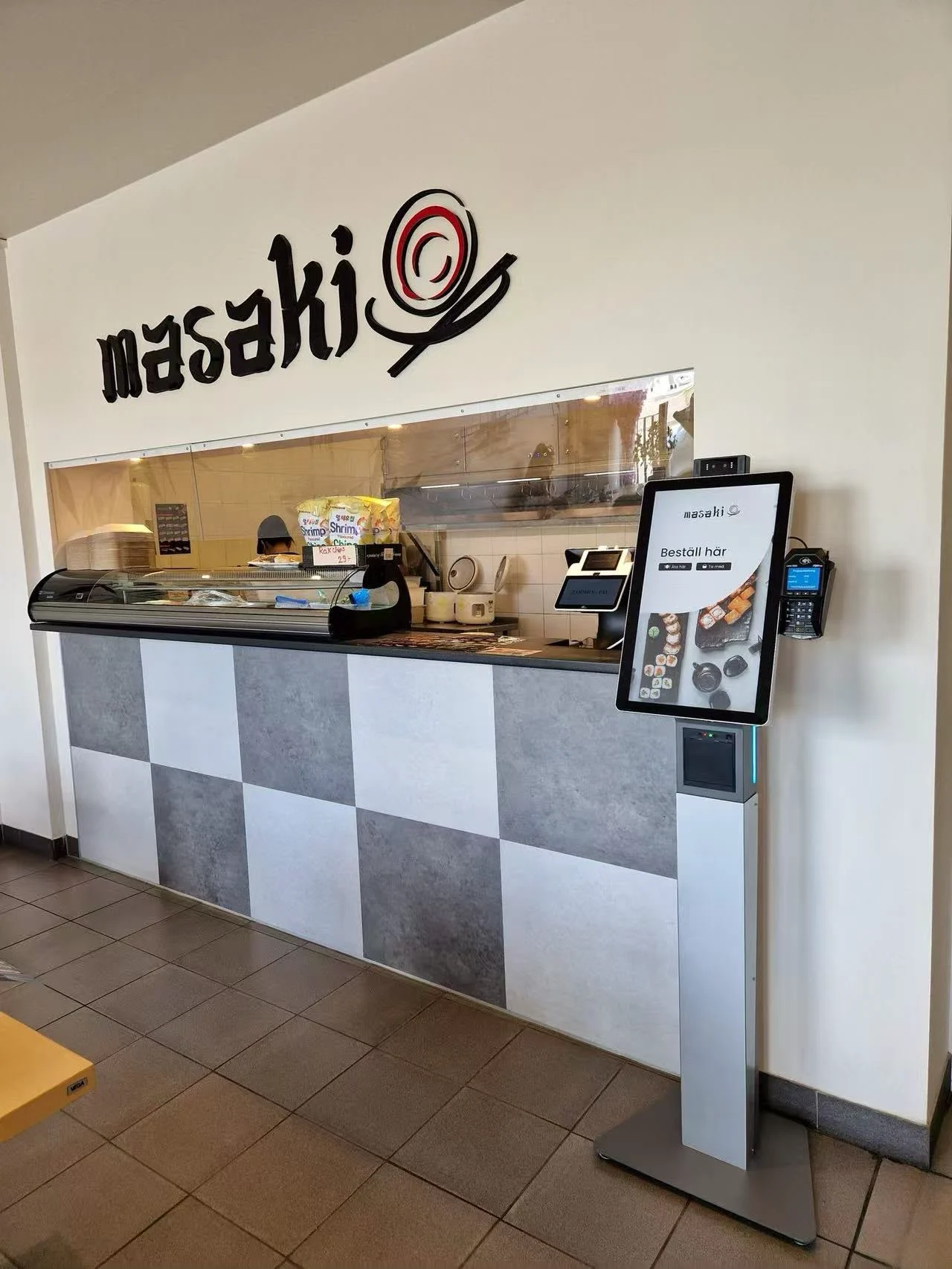 A self-order kiosk installed at a restaurant counter